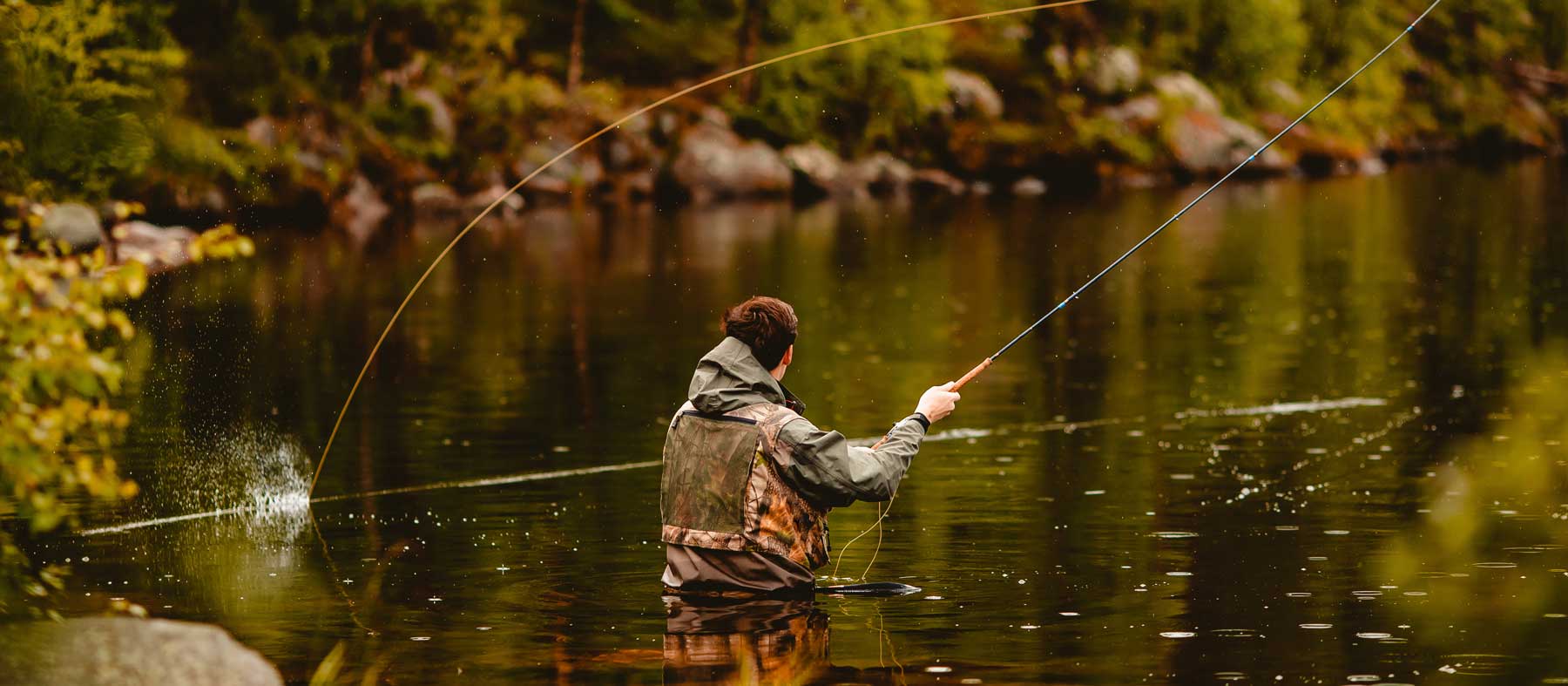Fisherman standing in a river